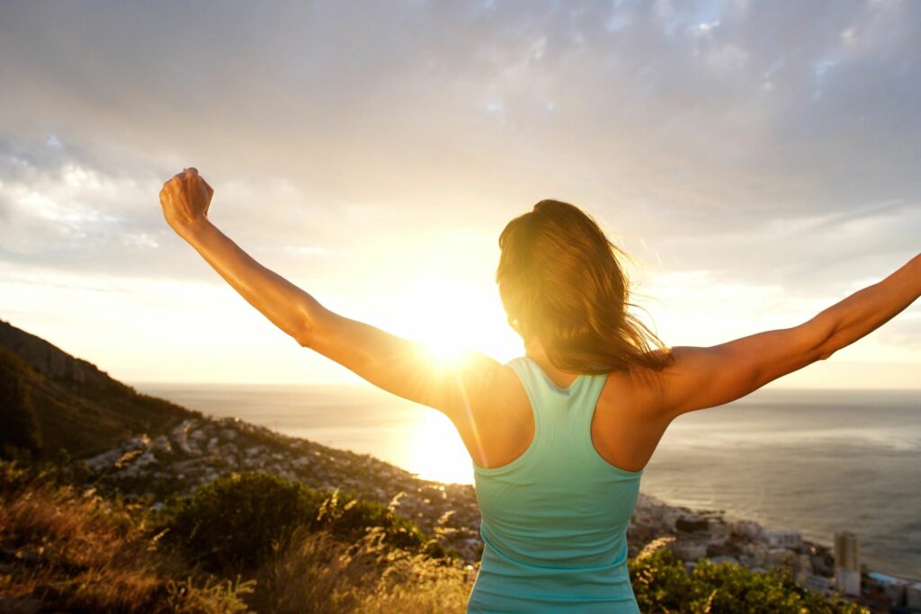 woman excited about summer in the mountains